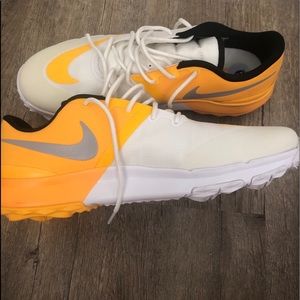 Nike yellow and white running shoes